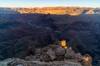 The sunrise light illuminates distant cliffs and the tip of a rock tower just below Comanche Point.